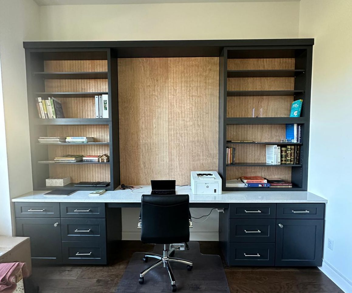 Custom built-in home office with dark cabinetry and open shelving
