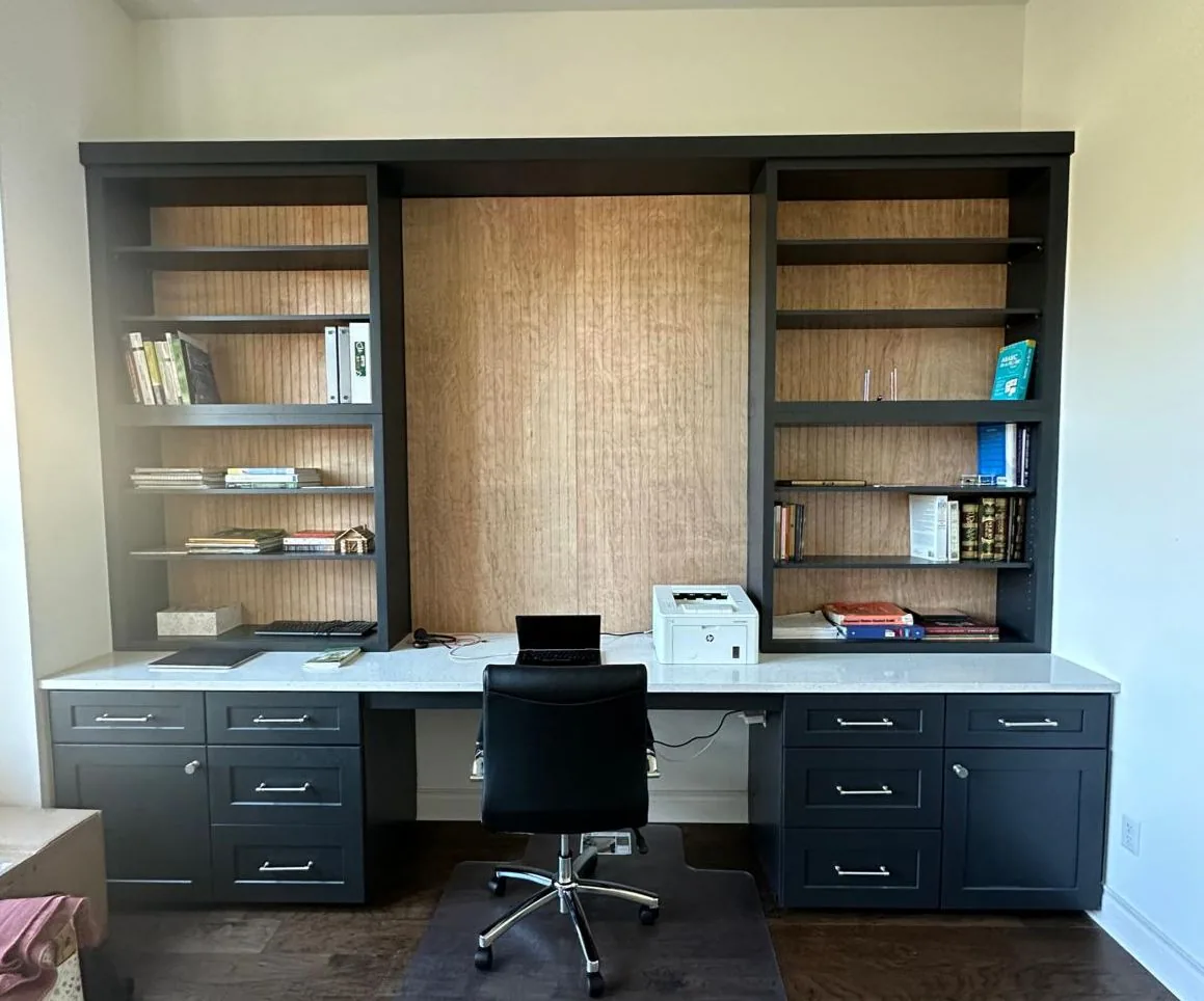 Custom built-in home office with dark cabinetry and open shelving