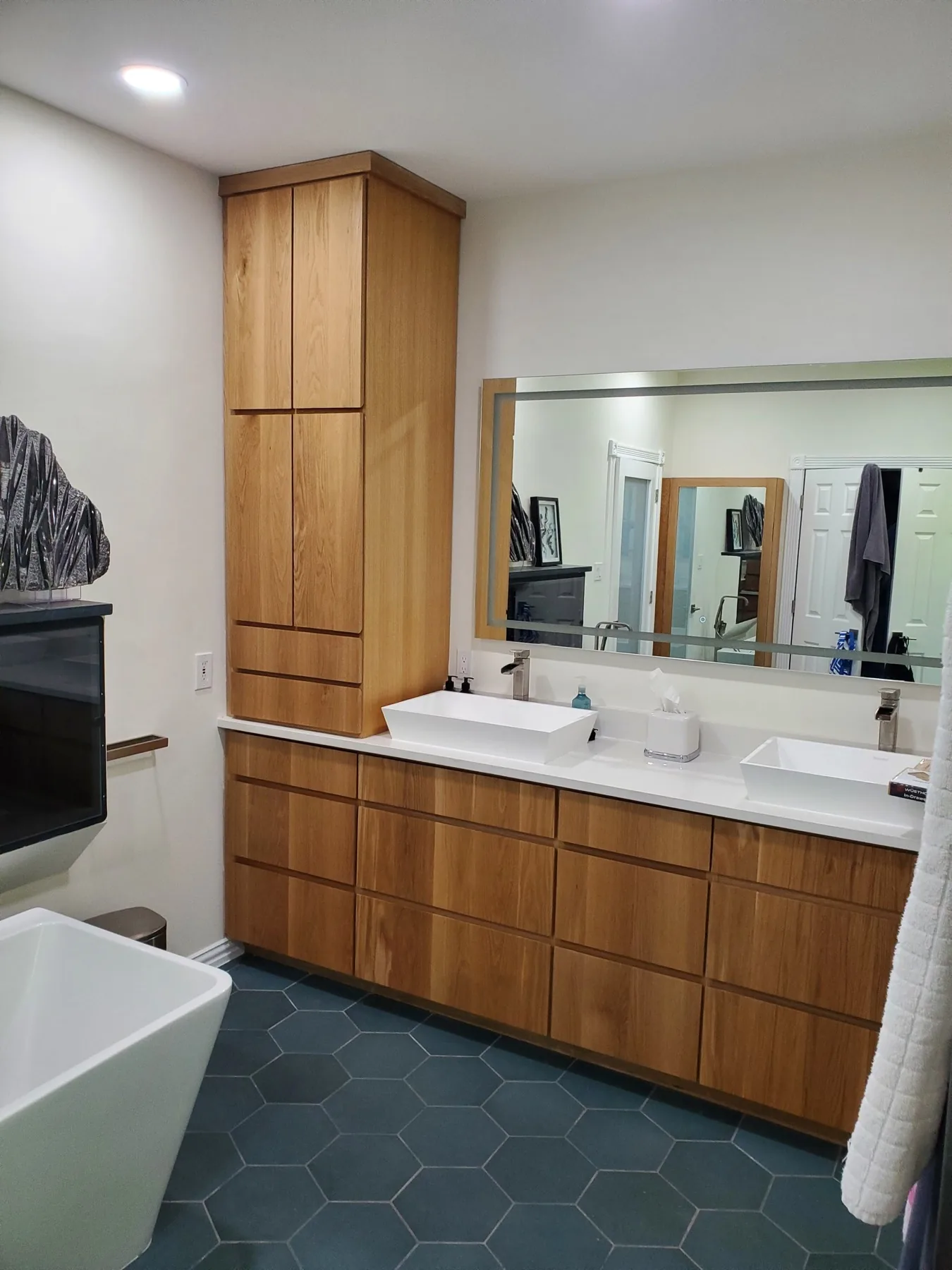 Floating white oak bathroom vanity with vessel sinks