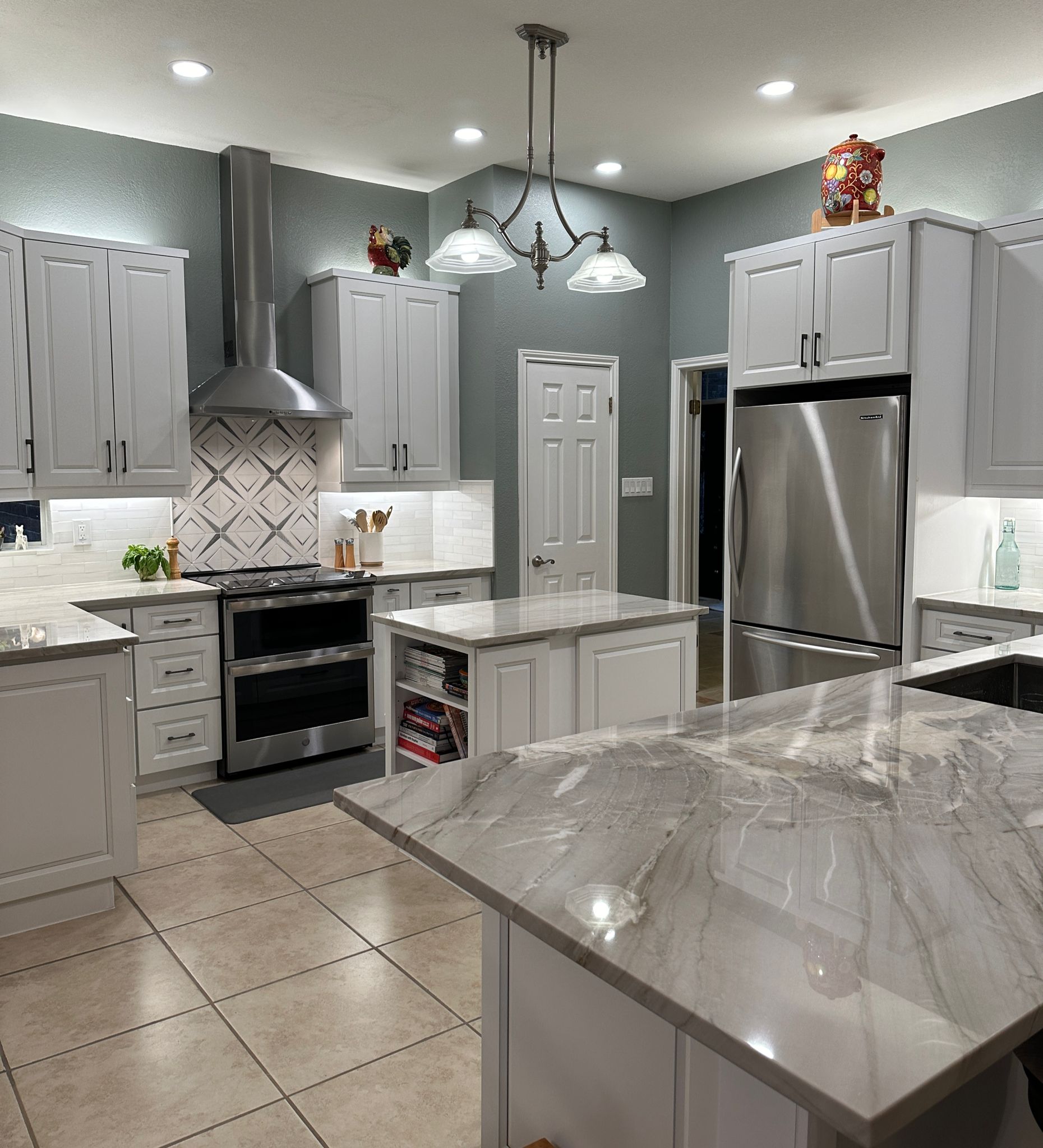 White kitchen with island and patterned backsplash