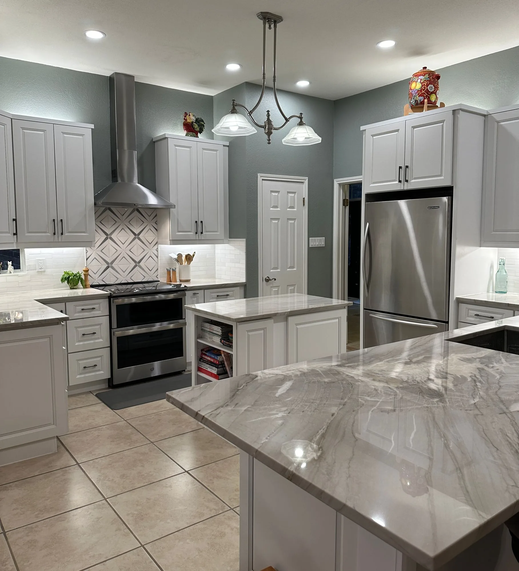 White kitchen with island and patterned backsplash